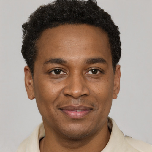 Joyful latino adult male with short  black hair and brown eyes