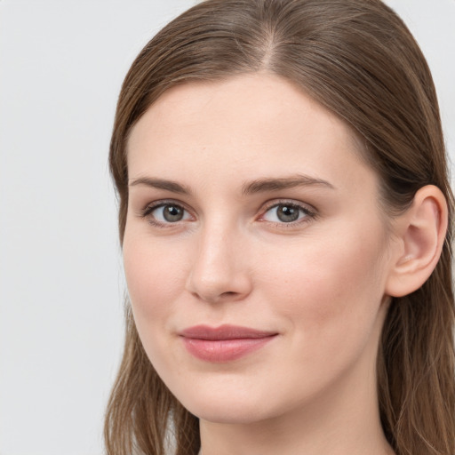 Joyful white young-adult female with long  brown hair and blue eyes