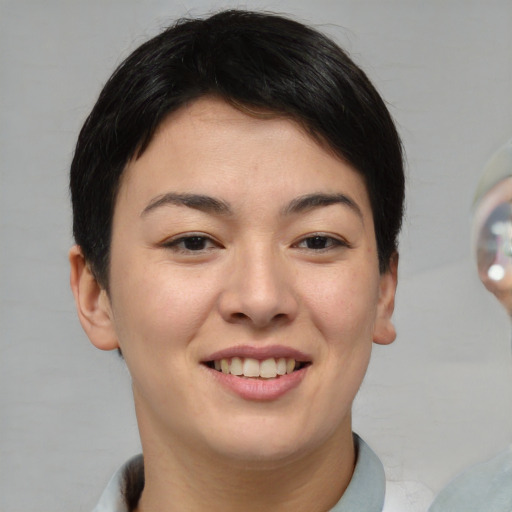 Joyful asian young-adult female with short  brown hair and brown eyes