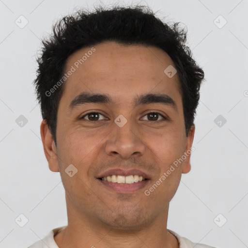 Joyful latino young-adult male with short  brown hair and brown eyes