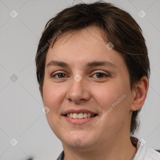 Joyful white young-adult female with short  brown hair and grey eyes