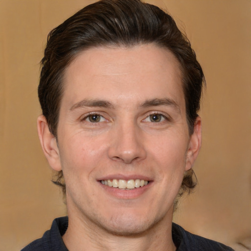 Joyful white adult male with short  brown hair and brown eyes