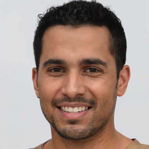 Joyful white young-adult male with short  black hair and brown eyes