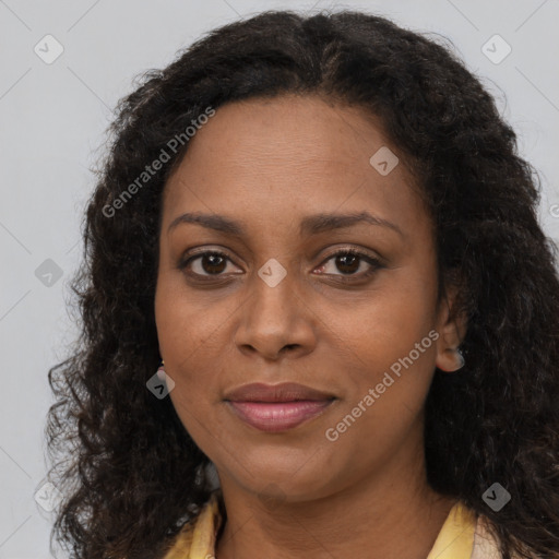 Joyful black young-adult female with long  brown hair and brown eyes