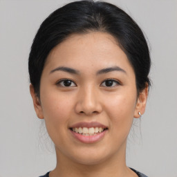 Joyful asian young-adult female with medium  black hair and brown eyes