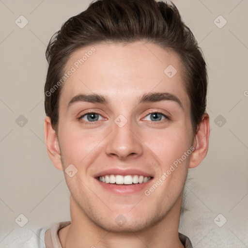 Joyful white young-adult male with short  brown hair and grey eyes