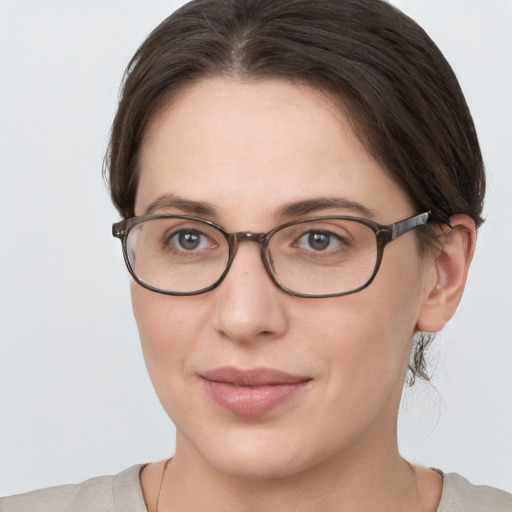 Joyful white young-adult female with medium  brown hair and grey eyes