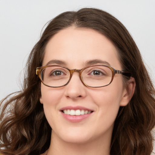 Joyful white young-adult female with long  brown hair and blue eyes