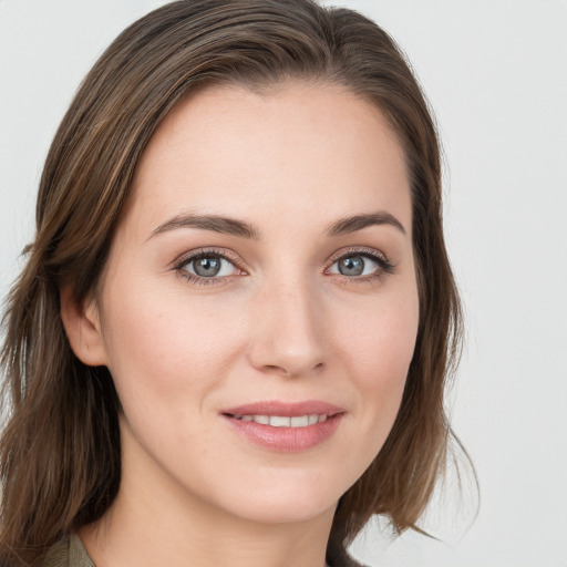 Joyful white young-adult female with medium  brown hair and blue eyes