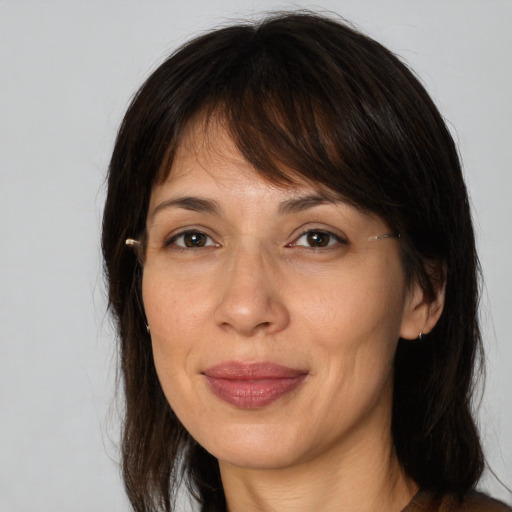 Joyful white adult female with medium  brown hair and brown eyes