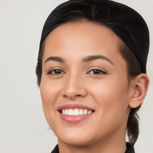 Joyful white young-adult female with long  black hair and brown eyes