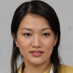 Joyful asian young-adult female with medium  brown hair and brown eyes