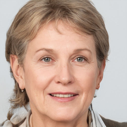 Joyful white adult female with medium  brown hair and grey eyes