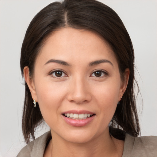 Joyful white young-adult female with medium  brown hair and brown eyes