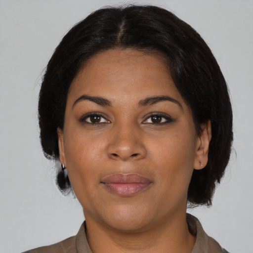 Joyful black young-adult female with medium  black hair and brown eyes