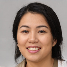 Joyful asian young-adult female with medium  black hair and brown eyes