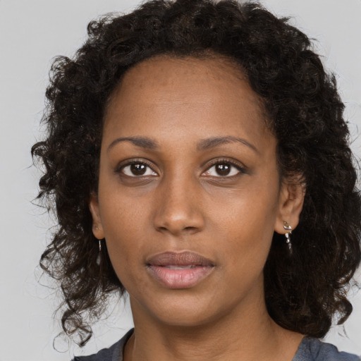 Neutral black young-adult female with long  brown hair and brown eyes