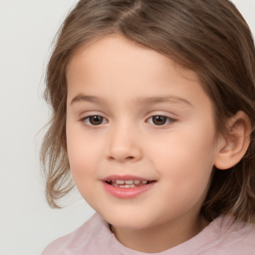 Joyful white child female with medium  brown hair and brown eyes