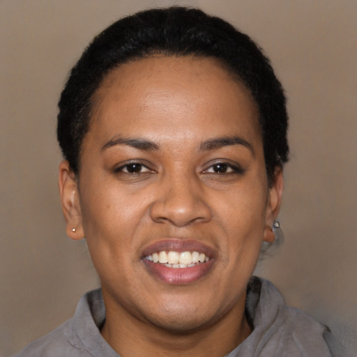 Joyful latino adult female with short  black hair and brown eyes