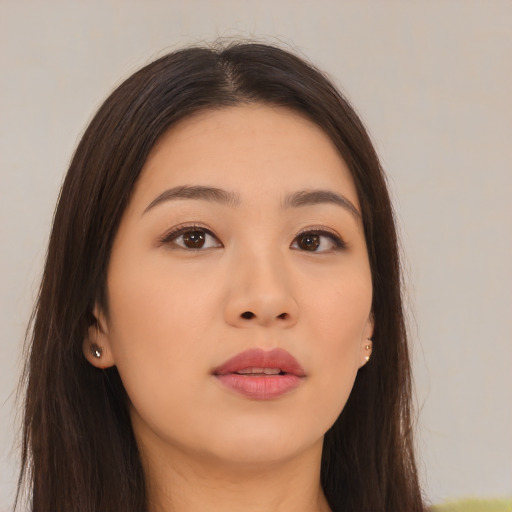 Joyful asian young-adult female with long  brown hair and brown eyes