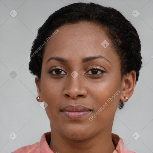 Joyful black young-adult female with short  brown hair and brown eyes