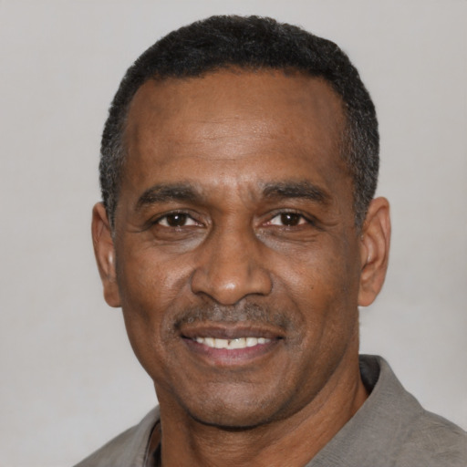 Joyful latino adult male with short  black hair and brown eyes