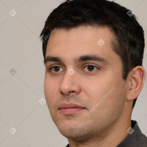 Neutral white young-adult male with short  black hair and brown eyes