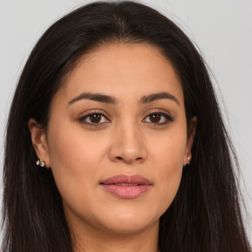 Joyful latino young-adult female with long  brown hair and brown eyes