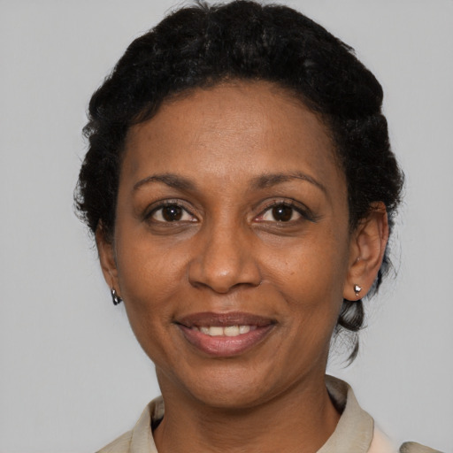 Joyful black adult female with short  black hair and brown eyes