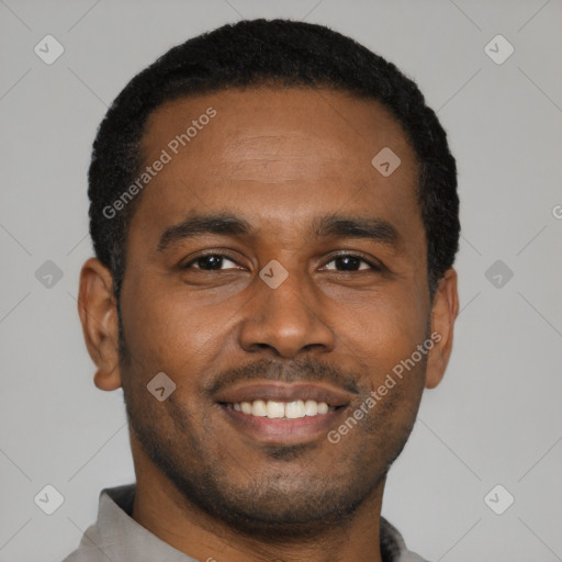 Joyful black young-adult male with short  black hair and brown eyes