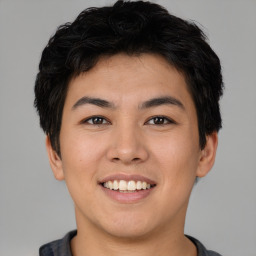 Joyful asian young-adult male with short  brown hair and brown eyes