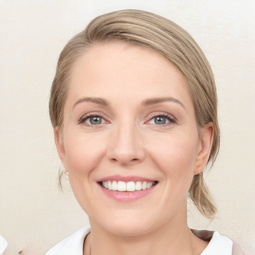 Joyful white young-adult female with medium  brown hair and blue eyes