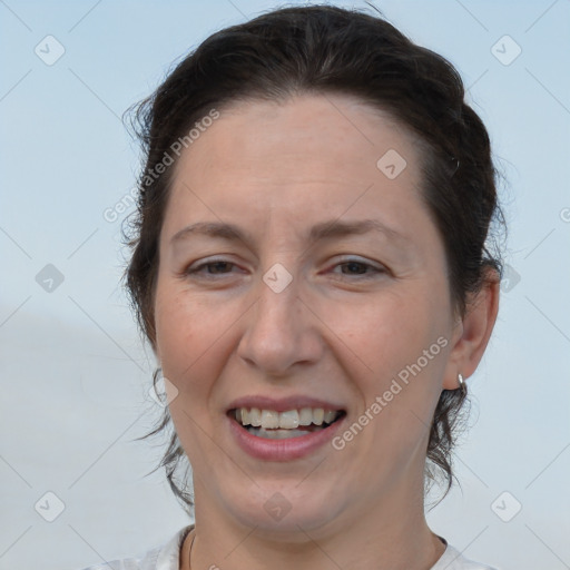 Joyful white adult female with short  brown hair and brown eyes