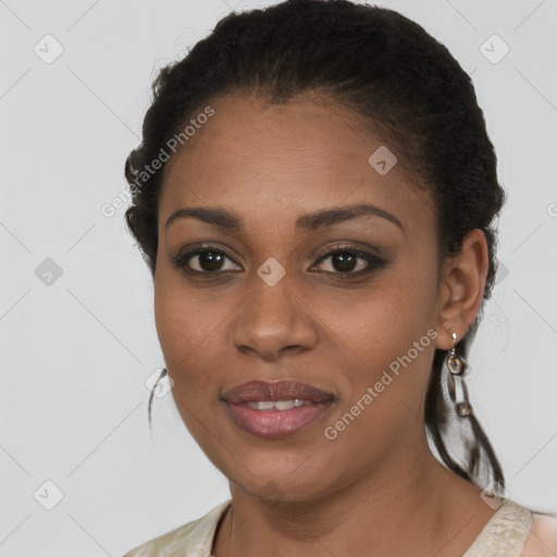 Joyful black young-adult female with long  brown hair and brown eyes