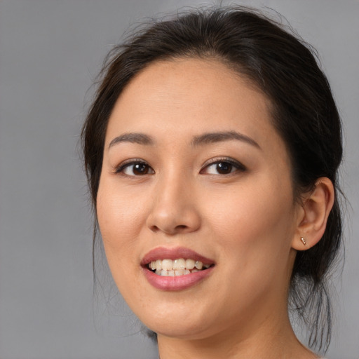 Joyful asian young-adult female with medium  brown hair and brown eyes