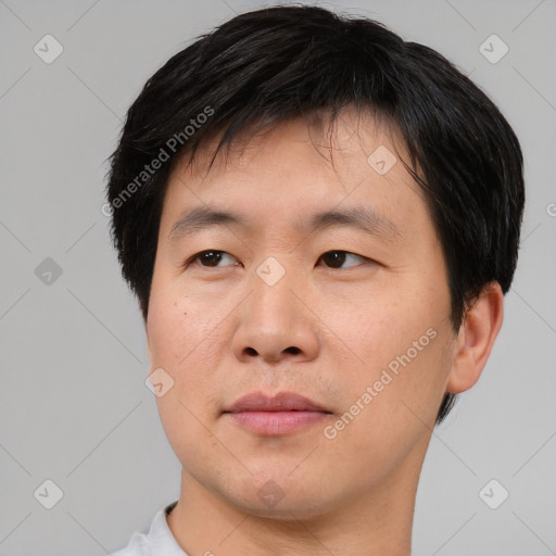 Joyful asian young-adult male with short  black hair and brown eyes