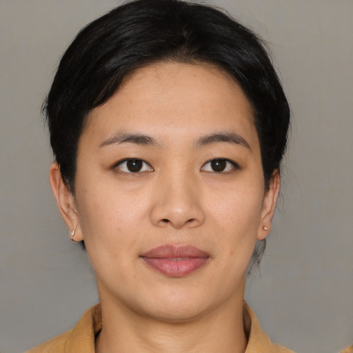 Joyful asian young-adult female with medium  brown hair and brown eyes