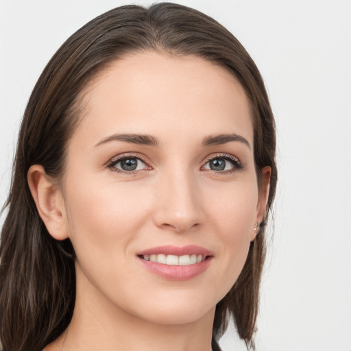 Joyful white young-adult female with long  brown hair and grey eyes