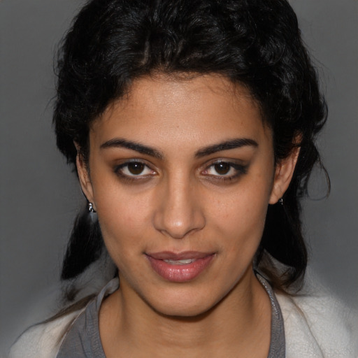 Joyful latino young-adult female with medium  brown hair and brown eyes