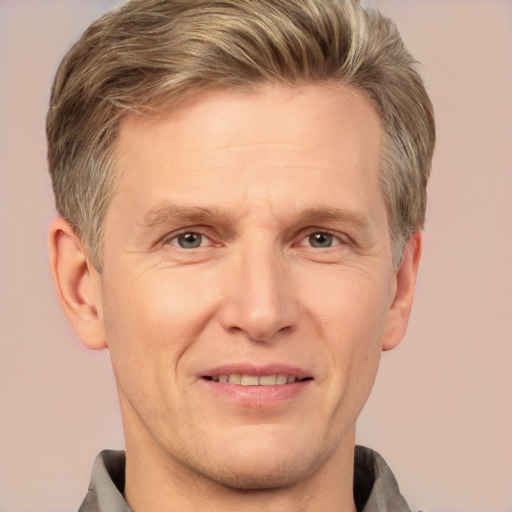 Joyful white adult male with short  brown hair and grey eyes