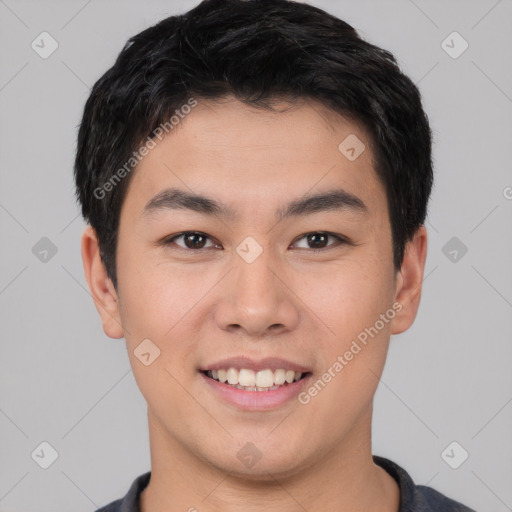 Joyful asian young-adult male with short  brown hair and brown eyes