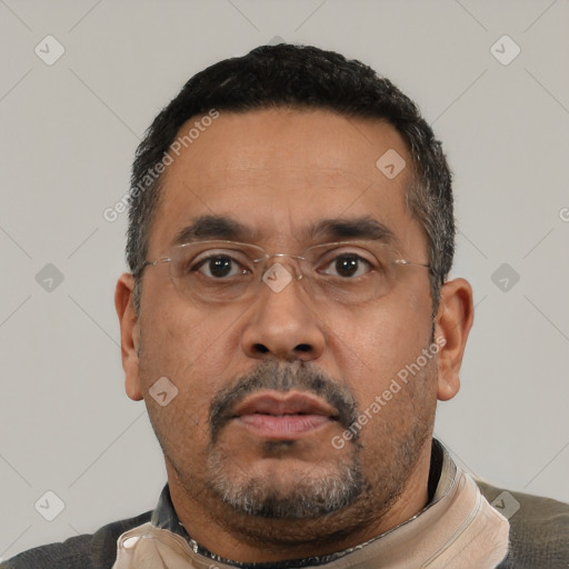 Neutral latino adult male with short  black hair and brown eyes