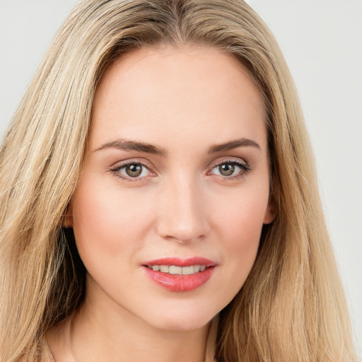 Joyful white young-adult female with long  brown hair and green eyes