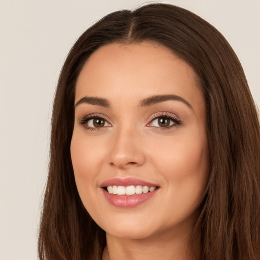 Joyful white young-adult female with long  brown hair and brown eyes