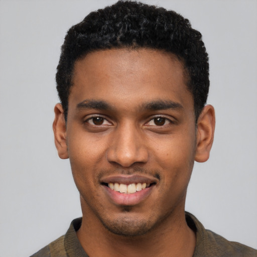 Joyful black young-adult male with short  black hair and brown eyes