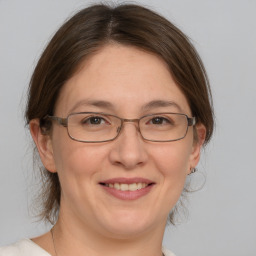 Joyful white adult female with medium  brown hair and brown eyes