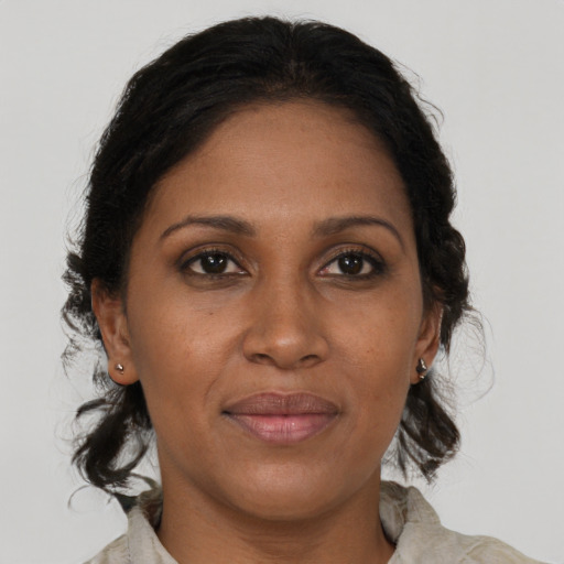 Joyful black adult female with medium  brown hair and brown eyes