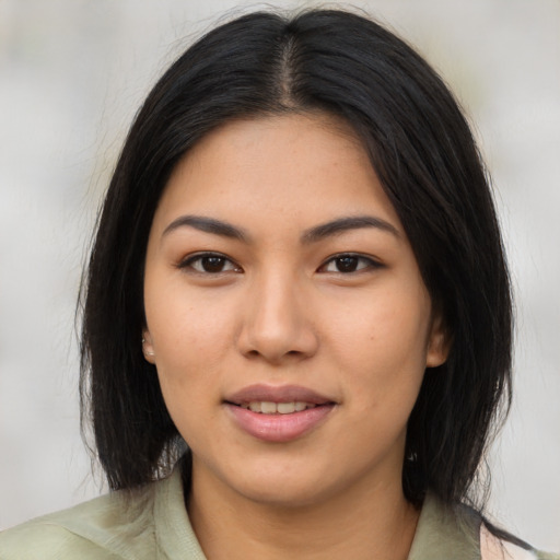 Joyful asian young-adult female with long  black hair and brown eyes