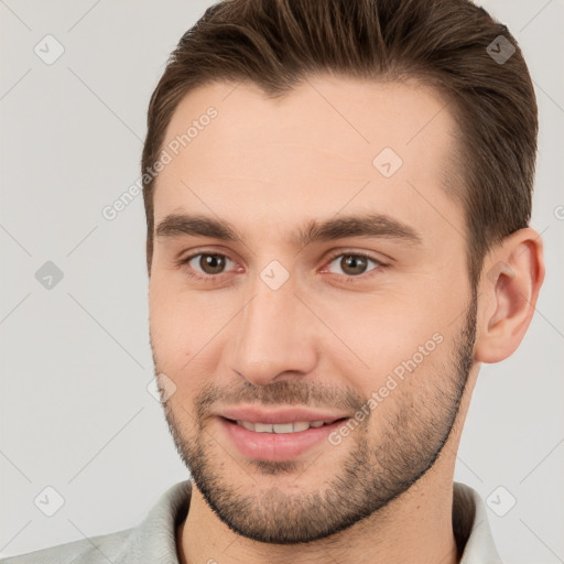 Joyful white young-adult male with short  brown hair and brown eyes