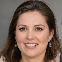 Joyful white adult female with medium  brown hair and grey eyes